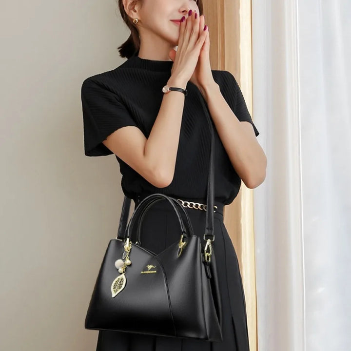 felina | black shoulder bag with elegant pendant